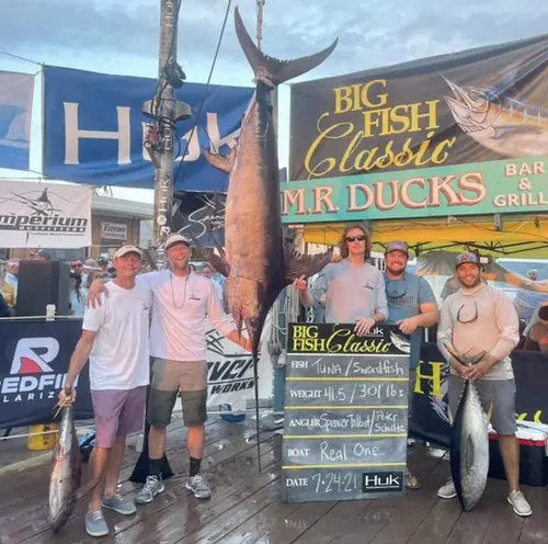 Photo of five men with a large swordsfish
