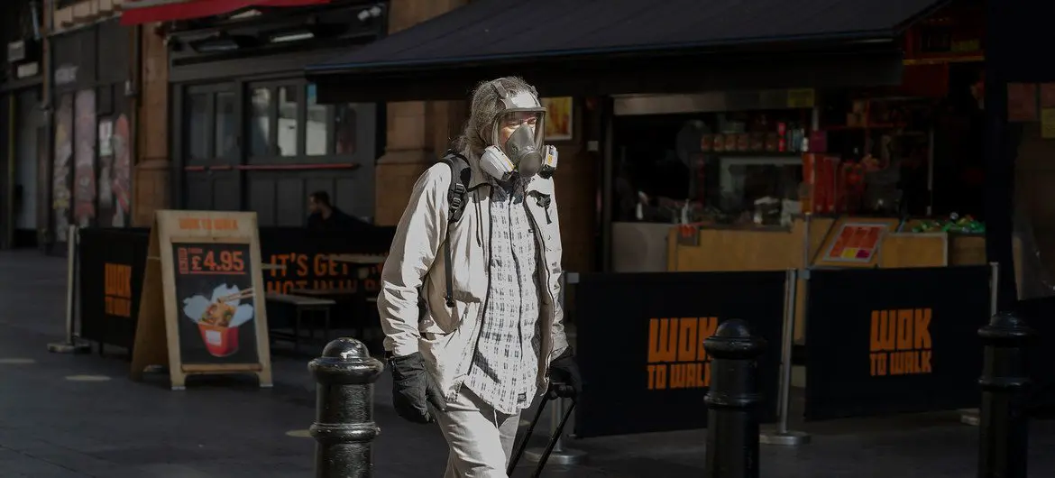A masked man walking in London's West End