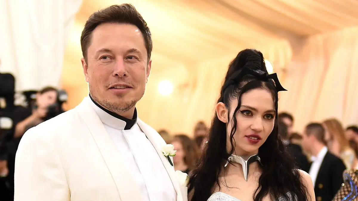 The woman next to Elon Musk auctioned off part of her soul