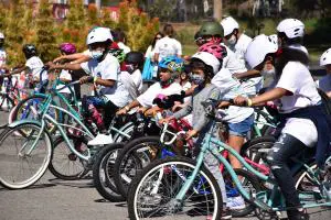 After getting fitted with their new helmets, all the kids lined up on their bicycles, excited to start the day's lessons.