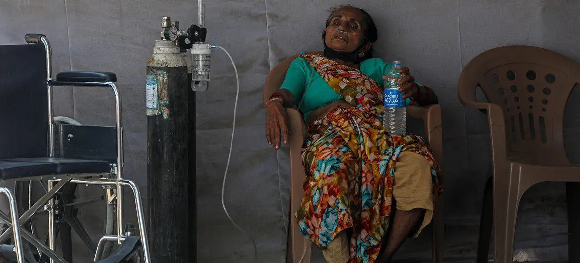 A patient who may have COVID-19 waits for medical assistance at a facility in the Goregaon area of Mumbai, India. A patient who may have COVID-19 waits for medical assistance at a facility in the Goregaon area of Mumbai, India.