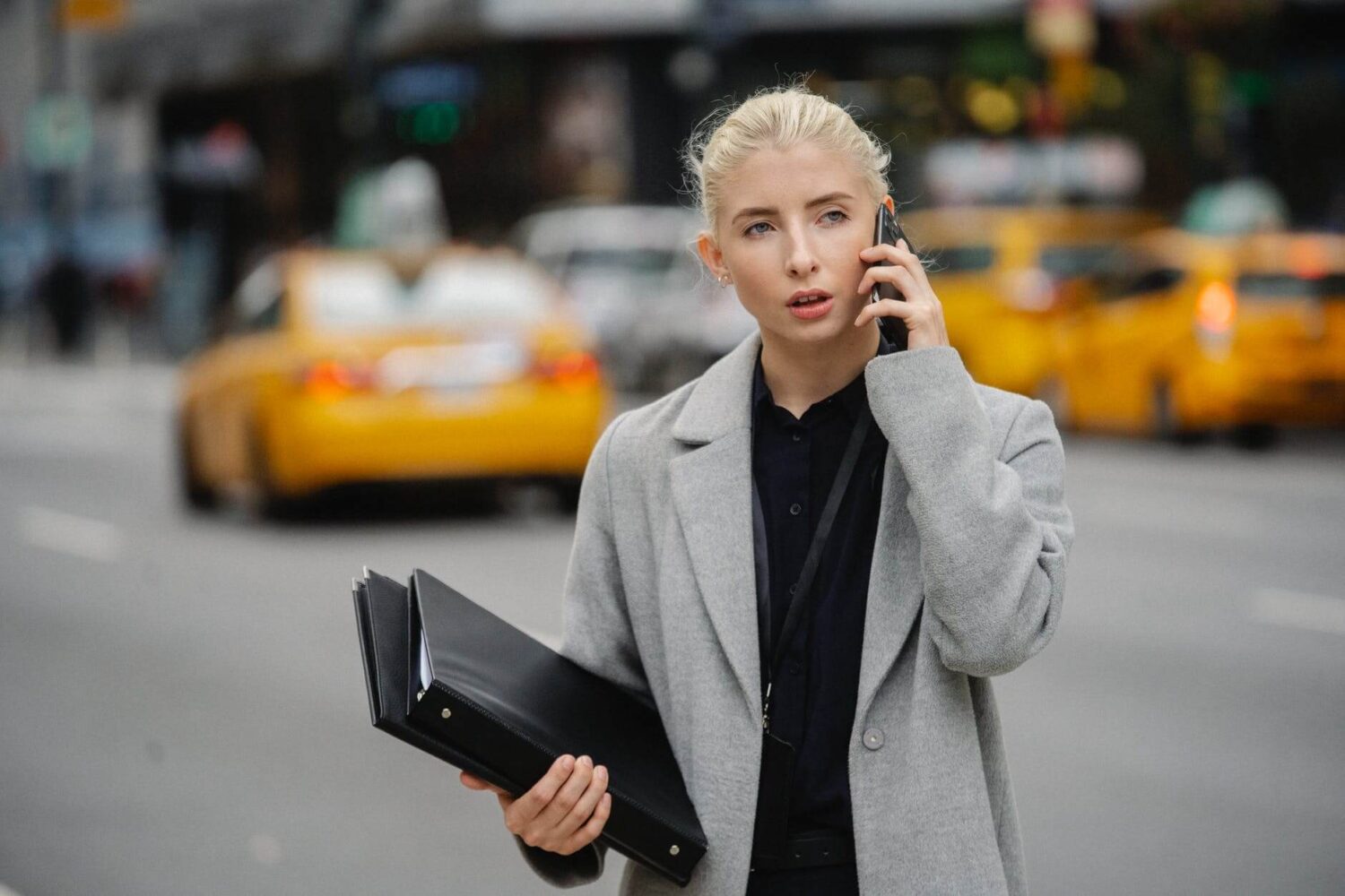 concentrated businesswoman talking on smartphone on street