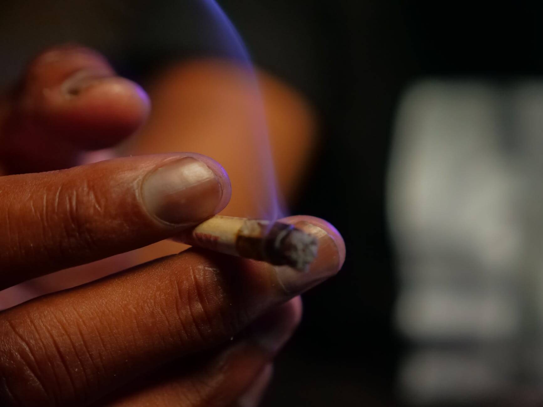 close up photo of person holding blunt