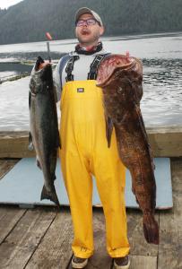 Waterfall Resort Alaska guest Bill Meairs has fun shaing a wide, gaping mouth with his king salmon and lingcod catches.
