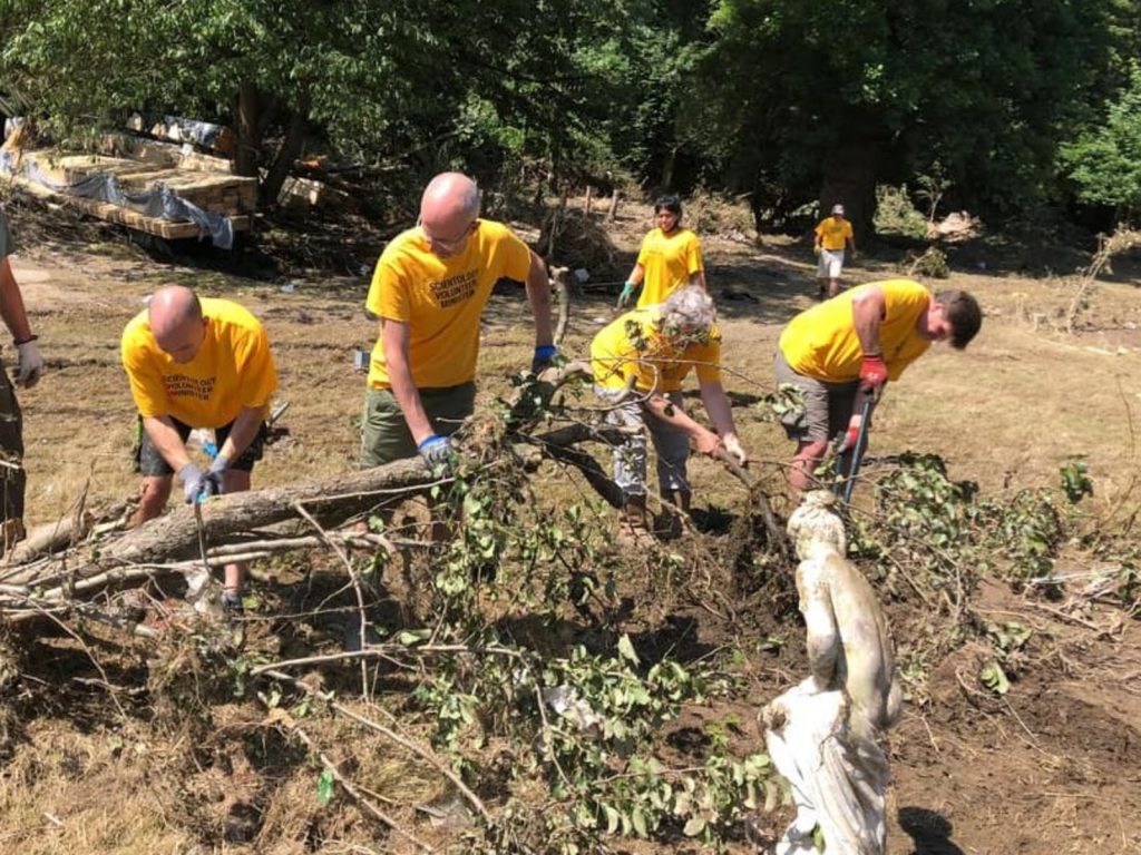 chopping fallen branches Volunteers help clean up after floods in Belgium