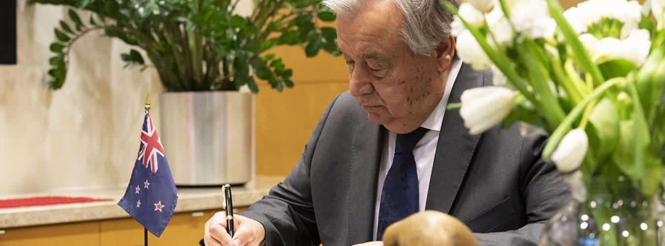 Secretary-General António Guterres signs the book of condolences at the Permanent Mission of New Zealand to the United Nations, for the lives lost in the terrorist attack at two mosques in Christchurch, New Zealand