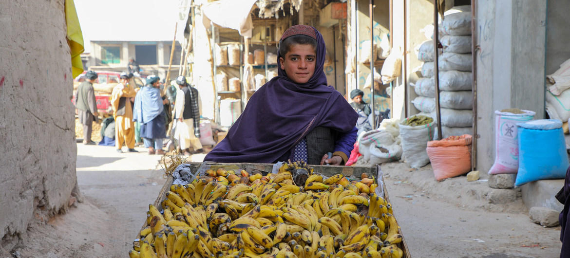 A 12-year-old boy, who does not go to school, sells bananas in Uruzgan Province in western Afghanistan. 