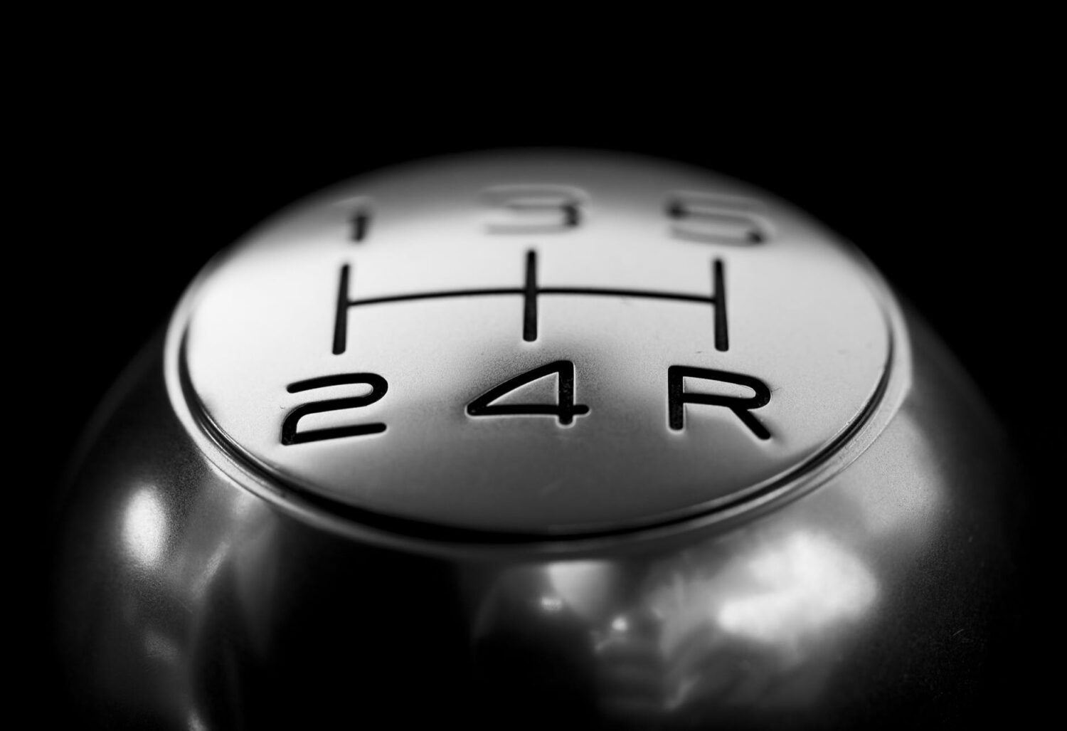 close up of gear shift over black background