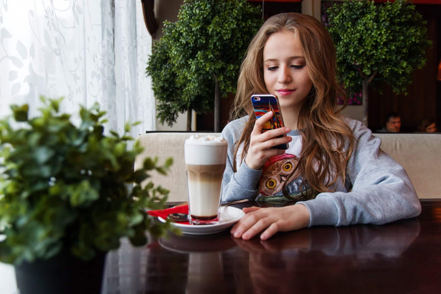 portrait of woman photographing with smart phone