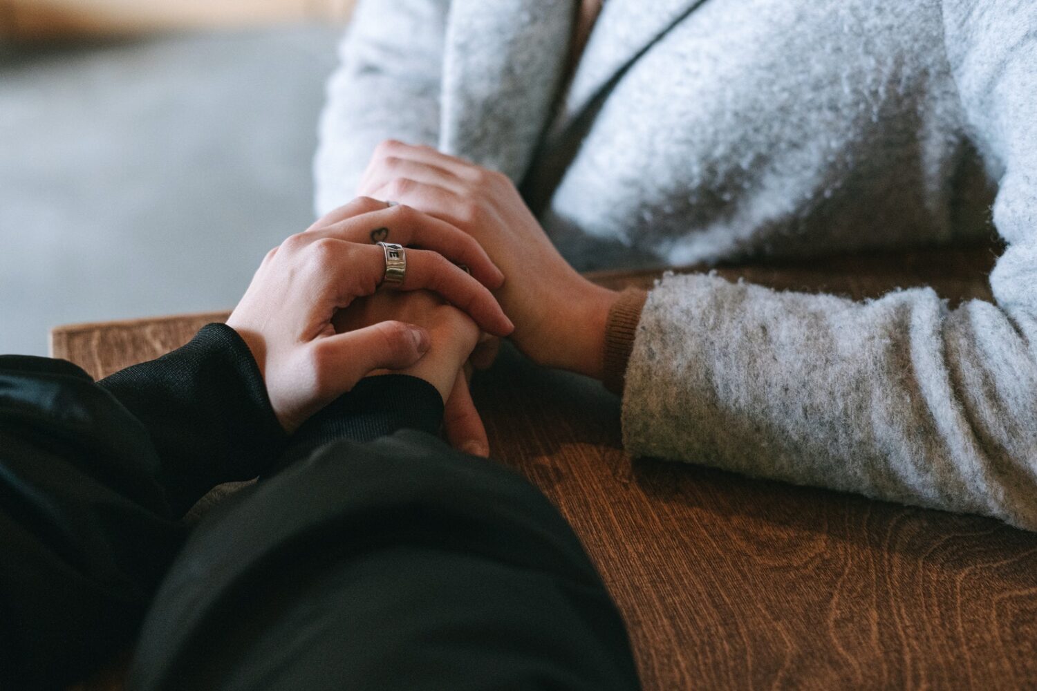 Person in Black Long Sleeve Shirt and Silver Ring