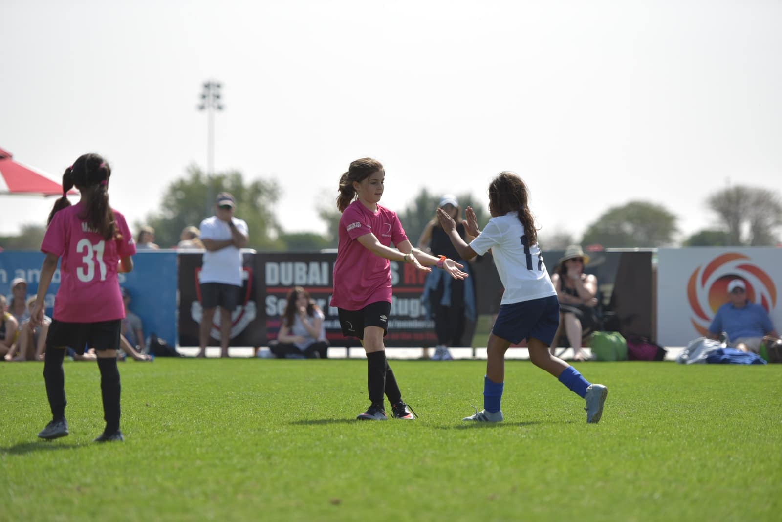 group of women playing soccer during daytime