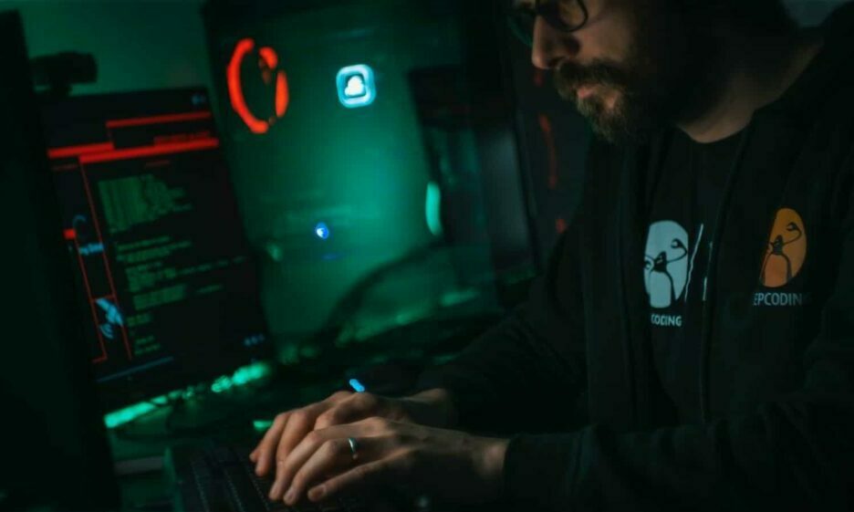 man in black jacket using computer