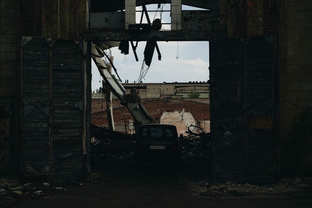 black car parked beside brown wooden house during daytime Donetsk