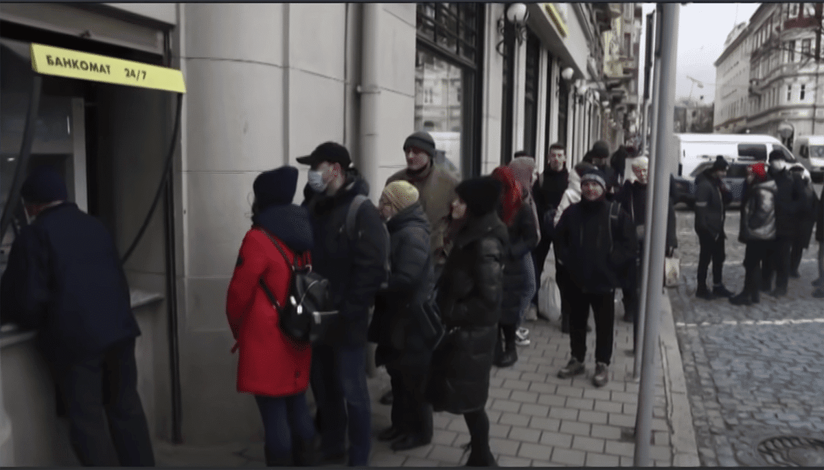 people waiting in line at an ATM in Russia