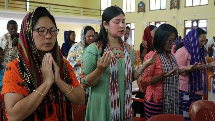 Miao women at prayer.