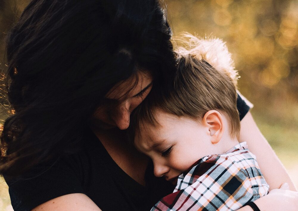 sad women withe a little boy in his arms