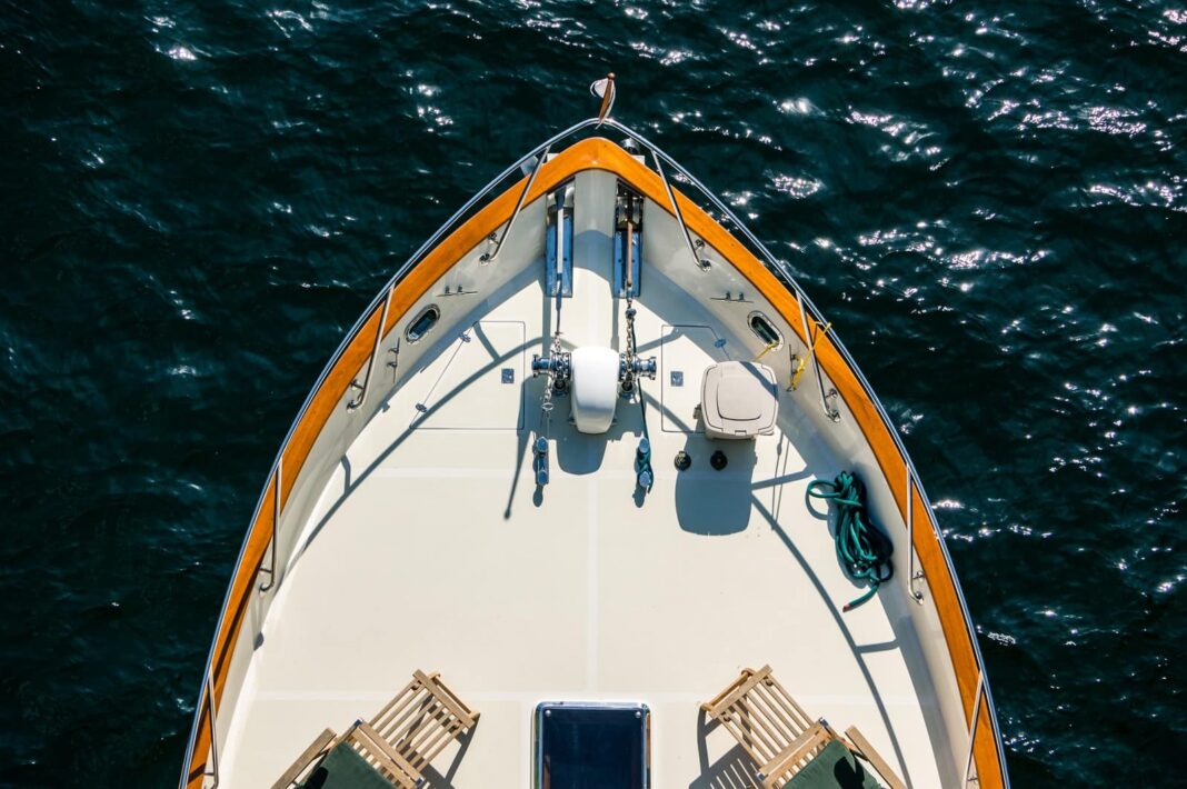 صورة جوية لقارب أبيض وبرتقالي على جسم مائي
