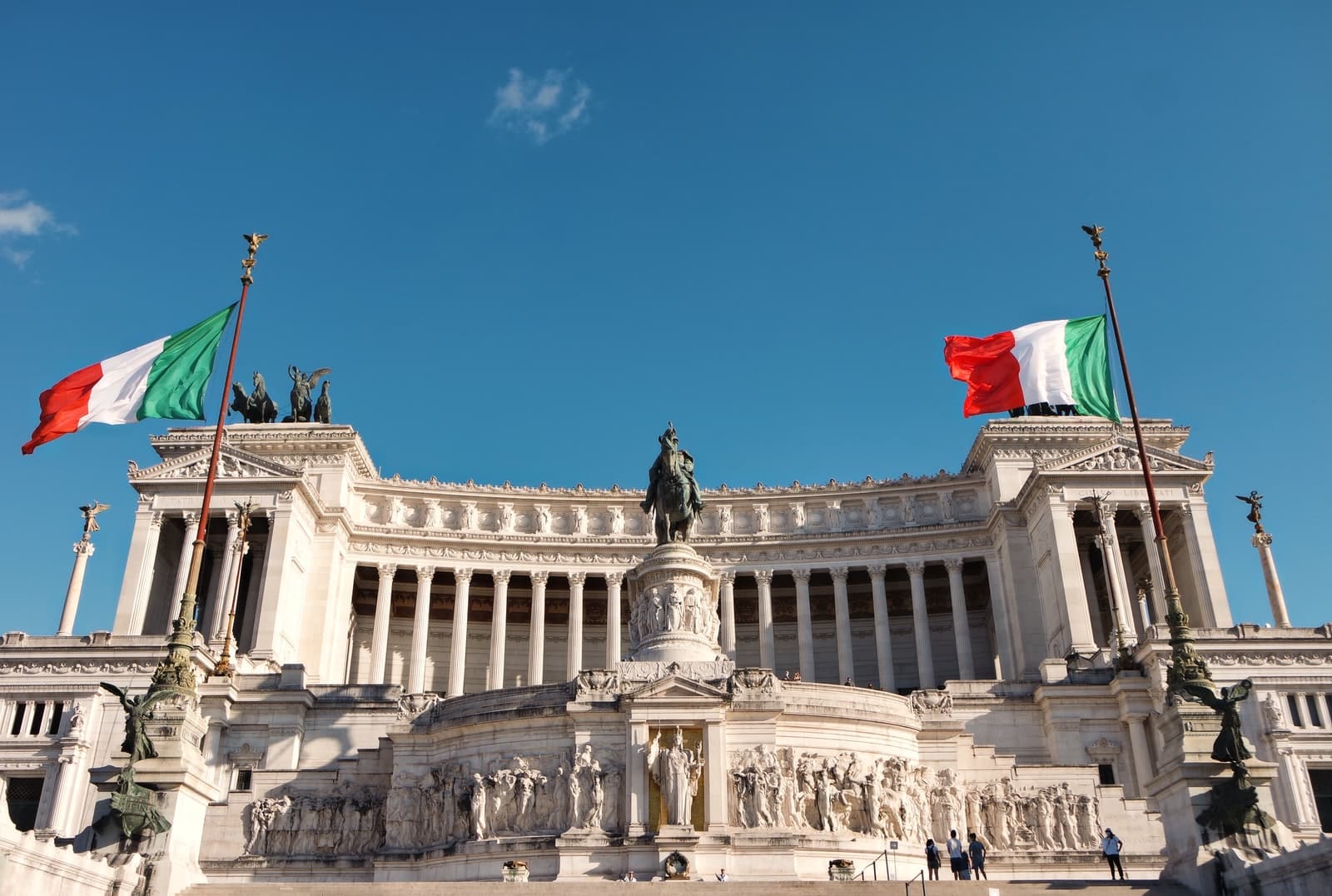 - State aid: Commission approves €700 million Italian schemewhite concrete building with statue under blue sky during daytime