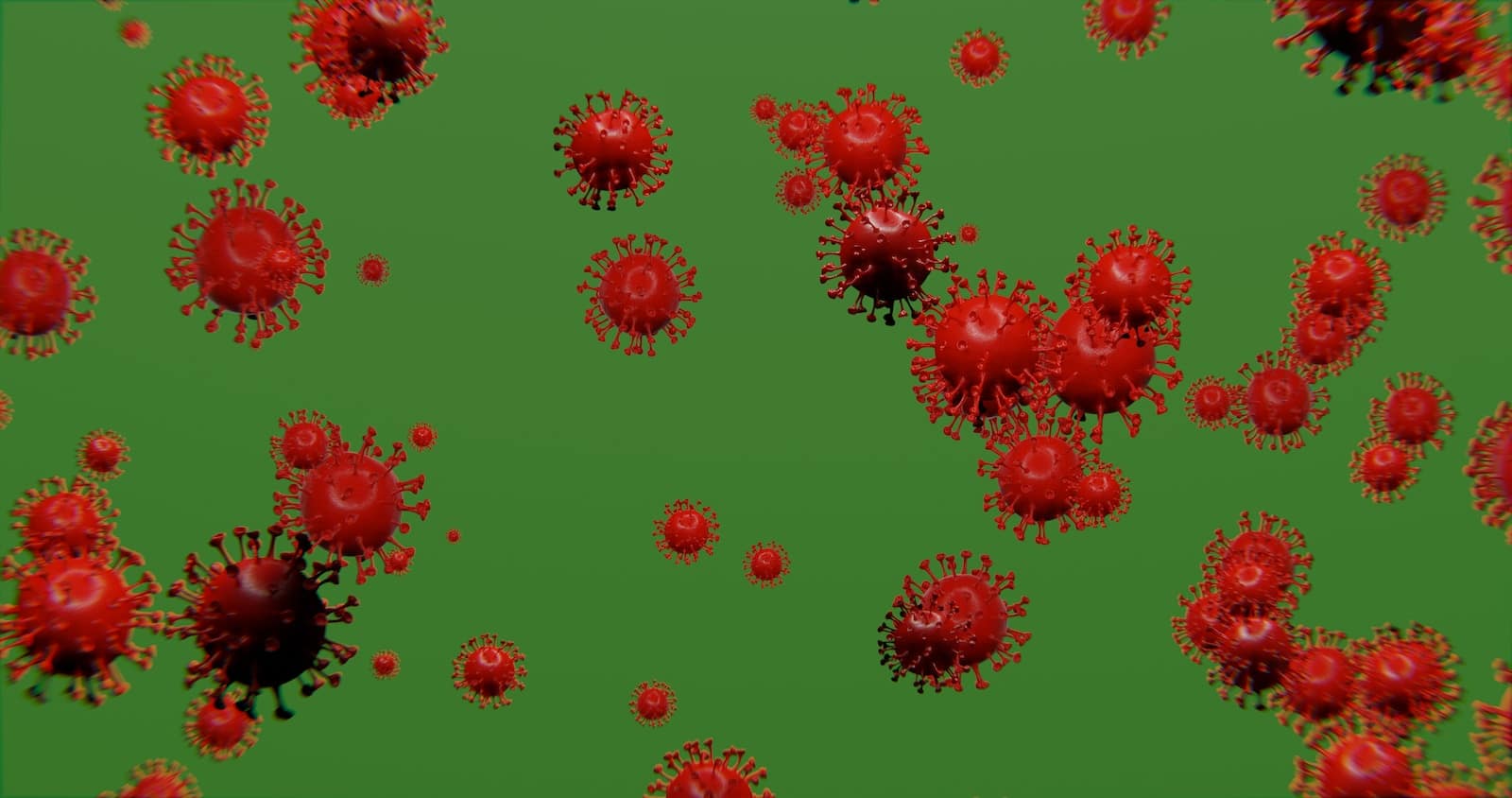 a group of red balls of blood on a green background