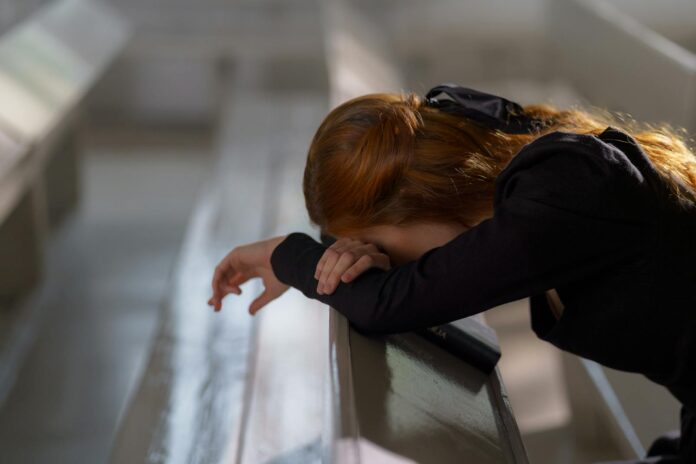 religious hate crimes - Woman suffering, Leaning on a Bench